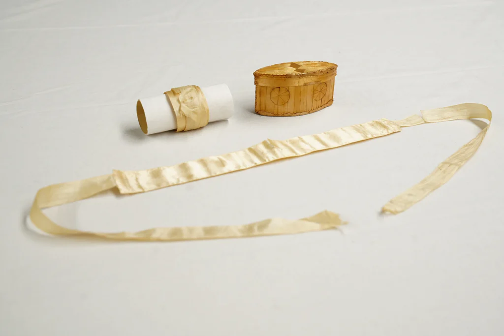 Ivory silk wedding garters and woven straw storage box, 1768, from the collections of The Charleston Museum. Worn by Harriott Pinckney when she married Daniel Horry on February 15, 1768 in Charleston. Harriott was the daughter of Eliza Lucas Pinckey.