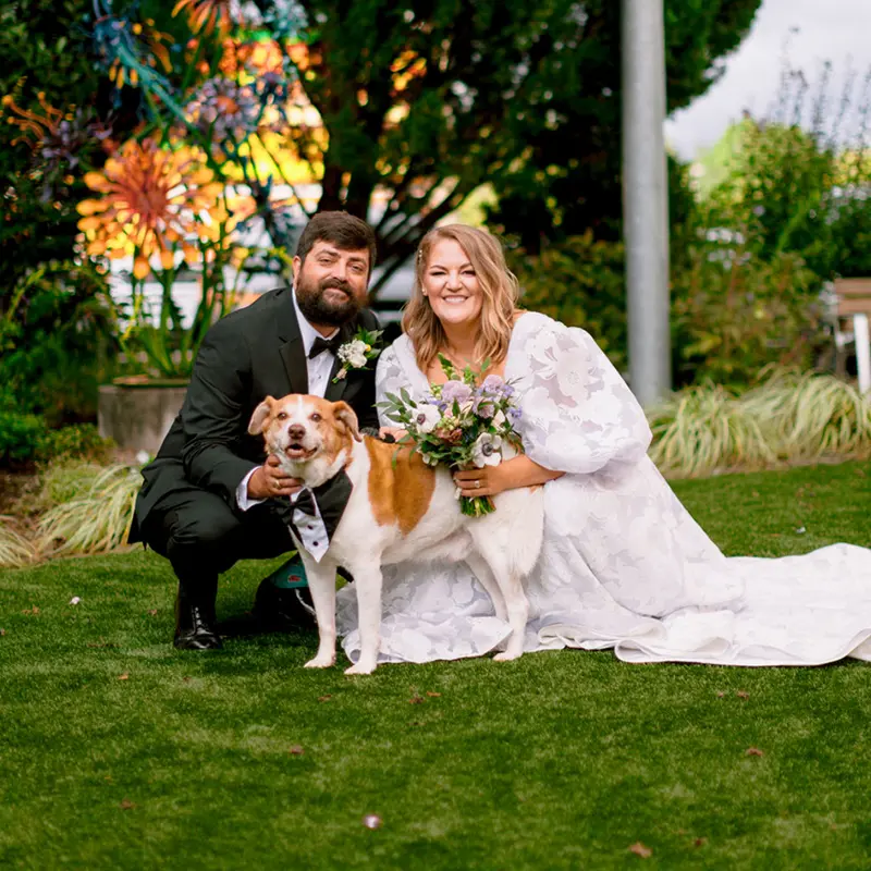 Fancy's Bridal image of married couple with dog wearing bowtie